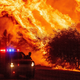 A law enforcement officer watches flames launch into the air as fire continues to spread during the Bear fire in Oroville, California on September 9, 2020. Dangerous dry winds whipped up California’s record-breaking wildfires and ignited new blazes, as hundreds were evacuated by helicopter and tens of thousands were plunged into darkness by power outages across the western United States.